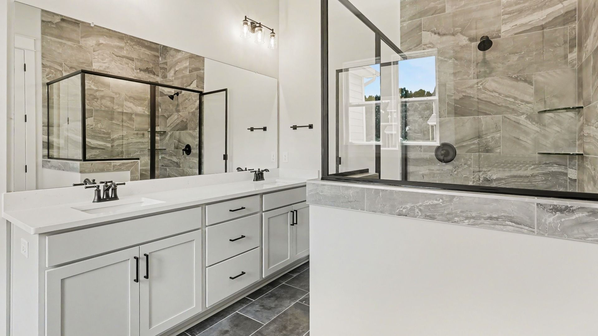 Primary bathroom with dual vanity and glass enclosed shower