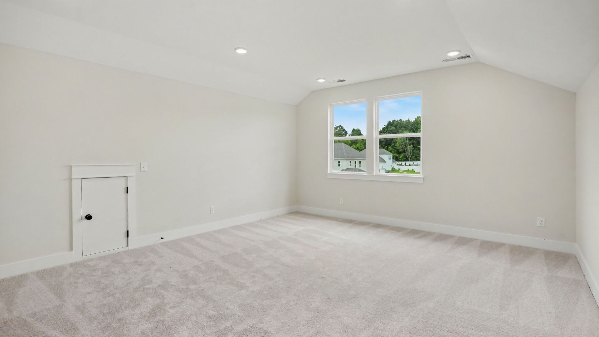 Loft area with carpet and windows