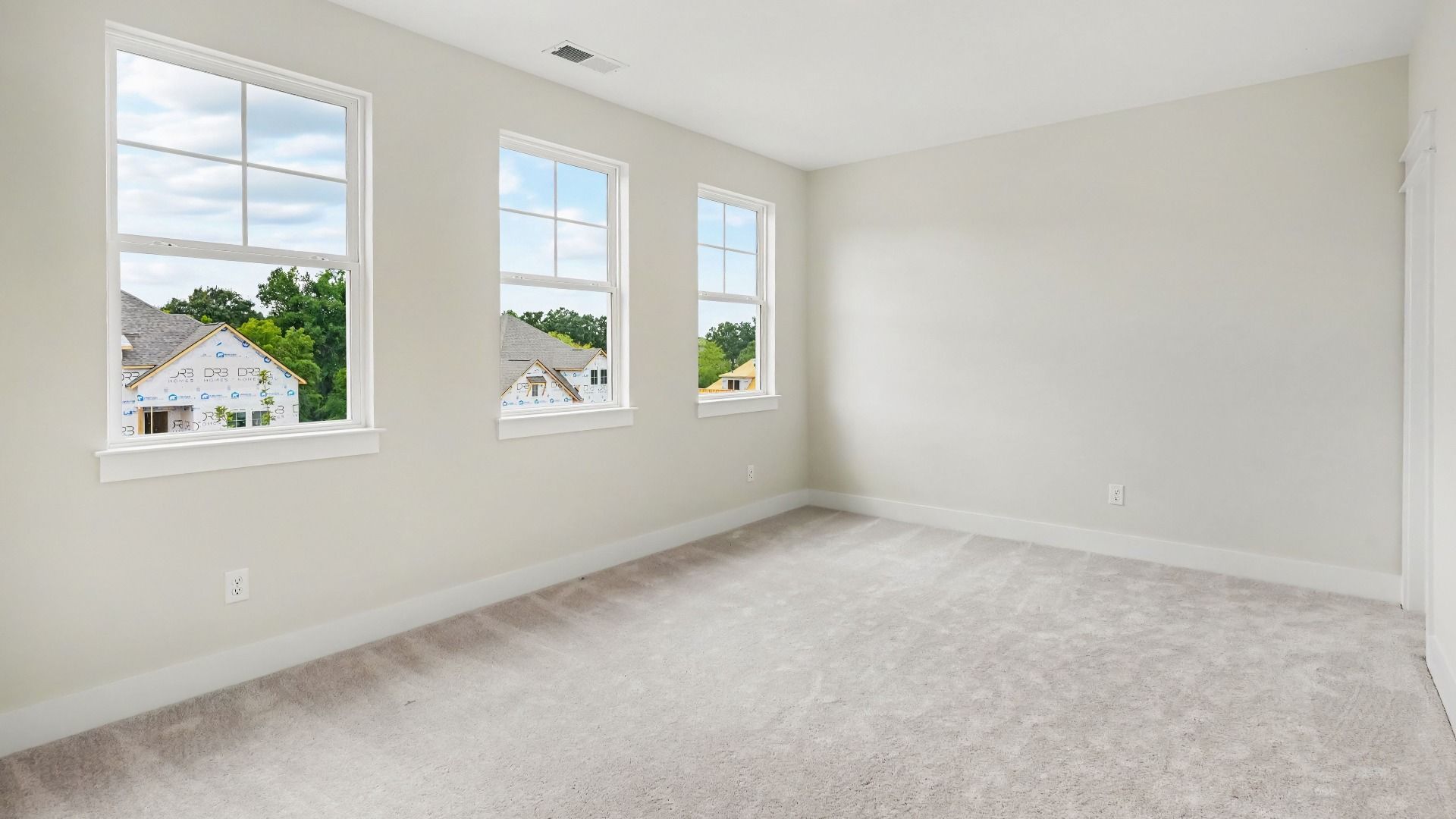 Secondary bathroom with carpet and windows