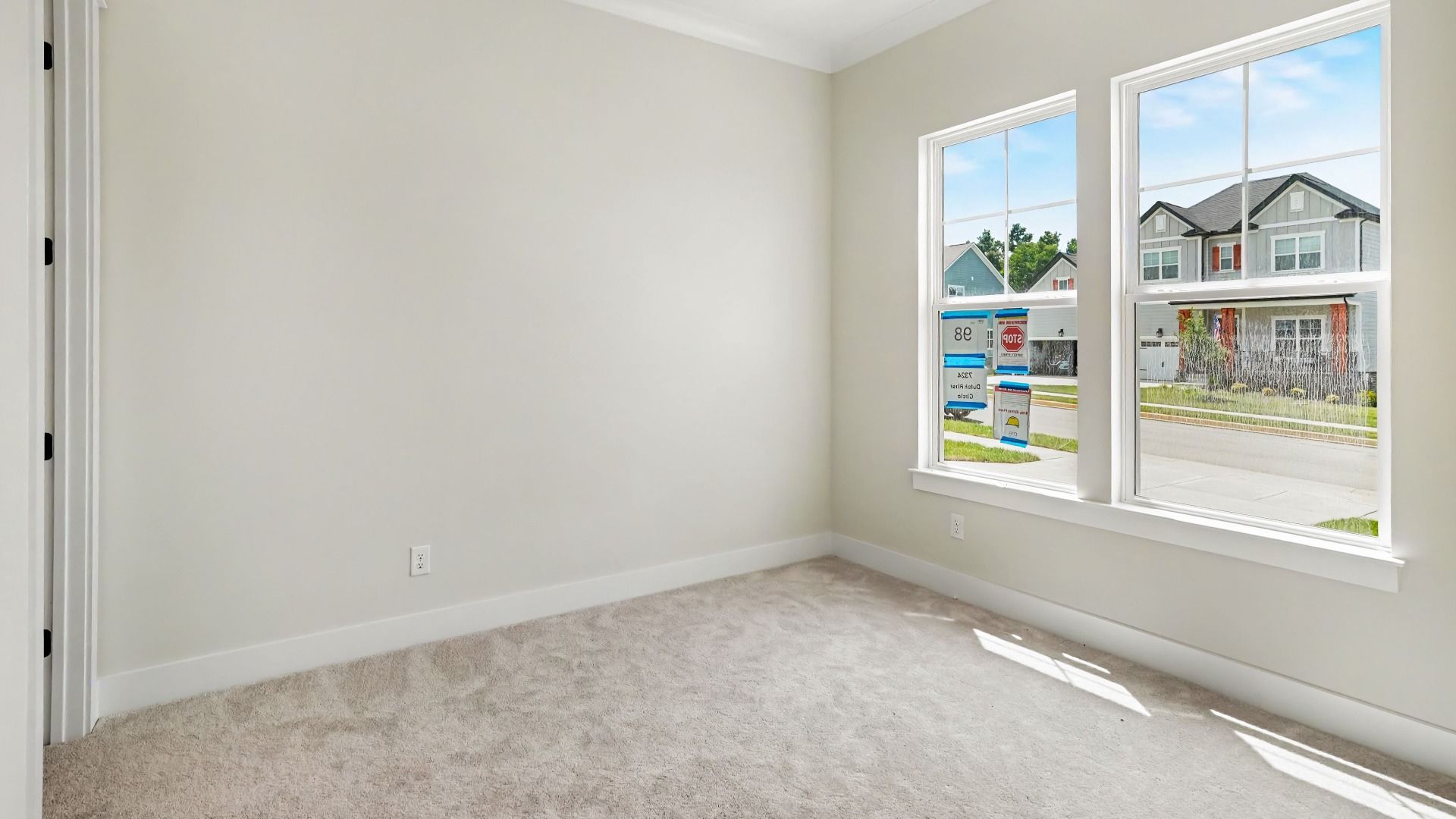 Secondary bathroom with carpet and windows