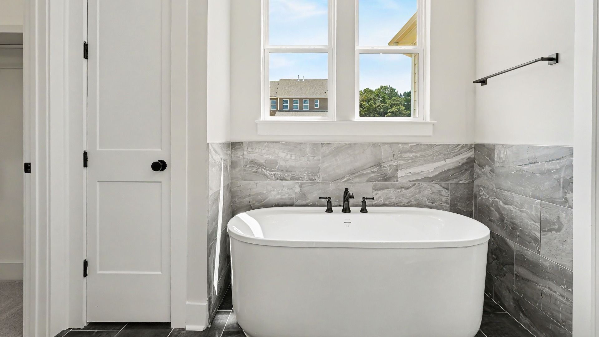 Primary bathroom with dedicated soaking tub and windows