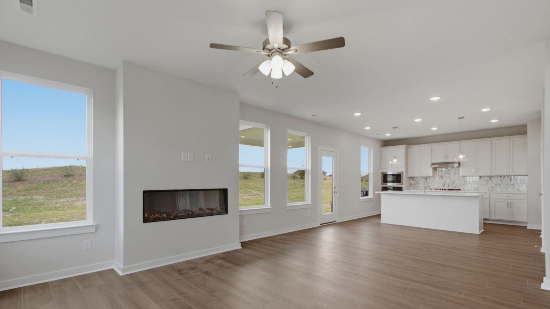 Open concept first floor with gathering room, cafe area, and kitchen