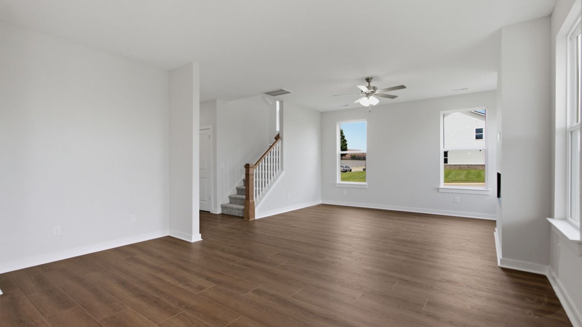 View from dining area into the living room with access to second floor