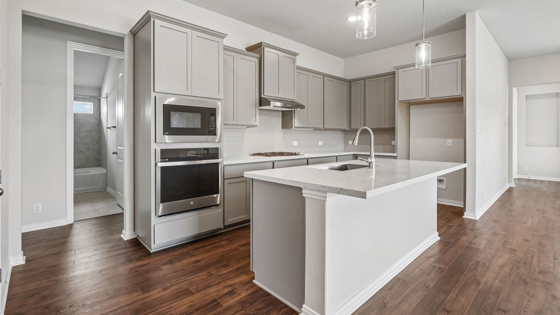 Upgraded kitchen is the heart of the home, featuring a gas cooktop and built-in appliances.