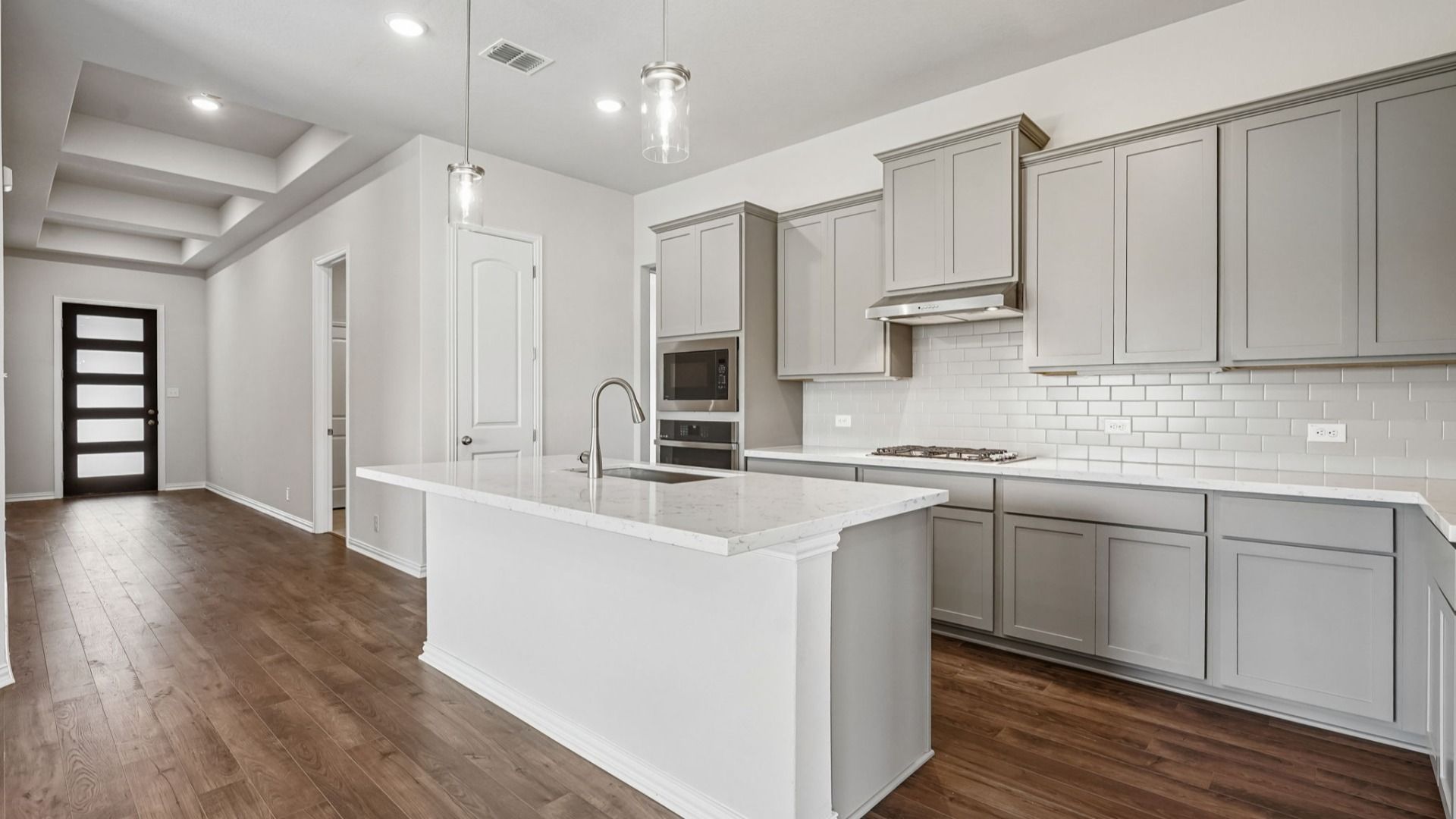 Upgraded kitchen is the heart of the home, featuring a gas cooktop and built-in appliances.
