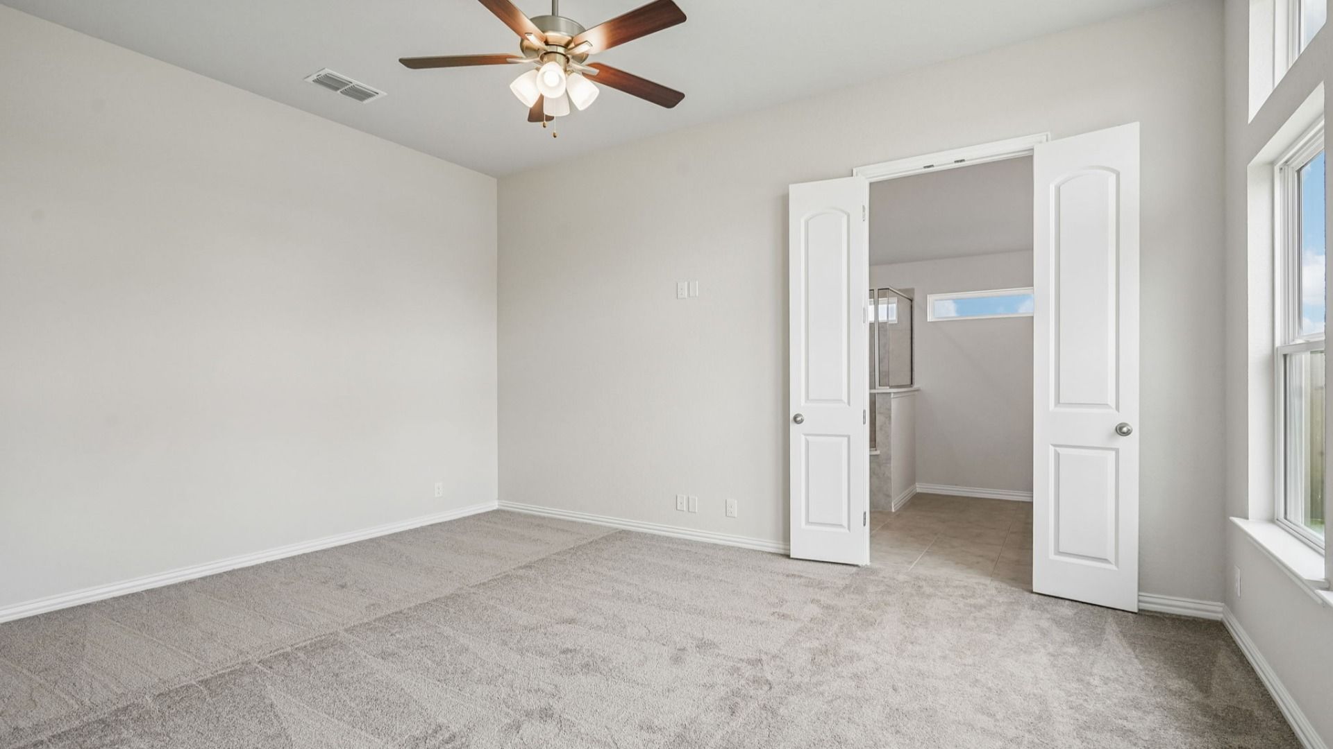 Spacious owner's suite features transom windows that bring in additional natural light.