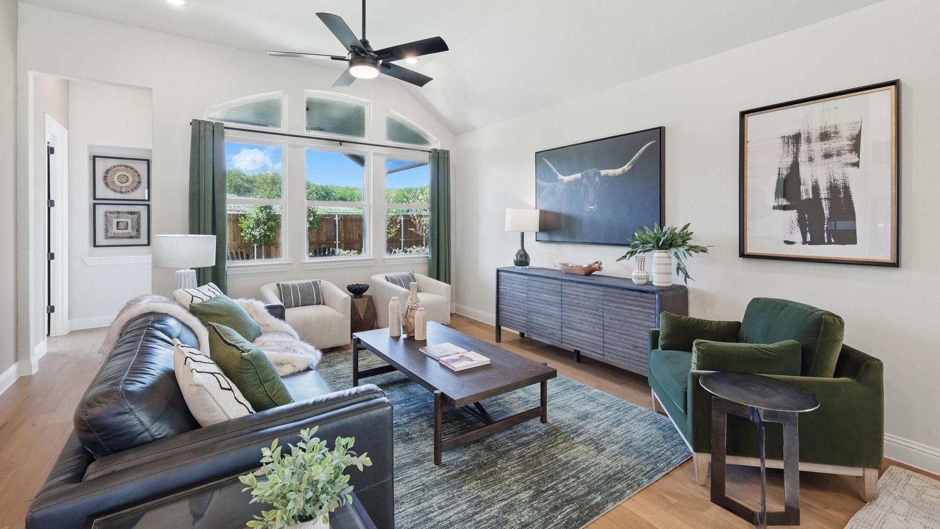 Inviting living room with vaulted ceilings, abundant natural light, and stylish modern finishes.