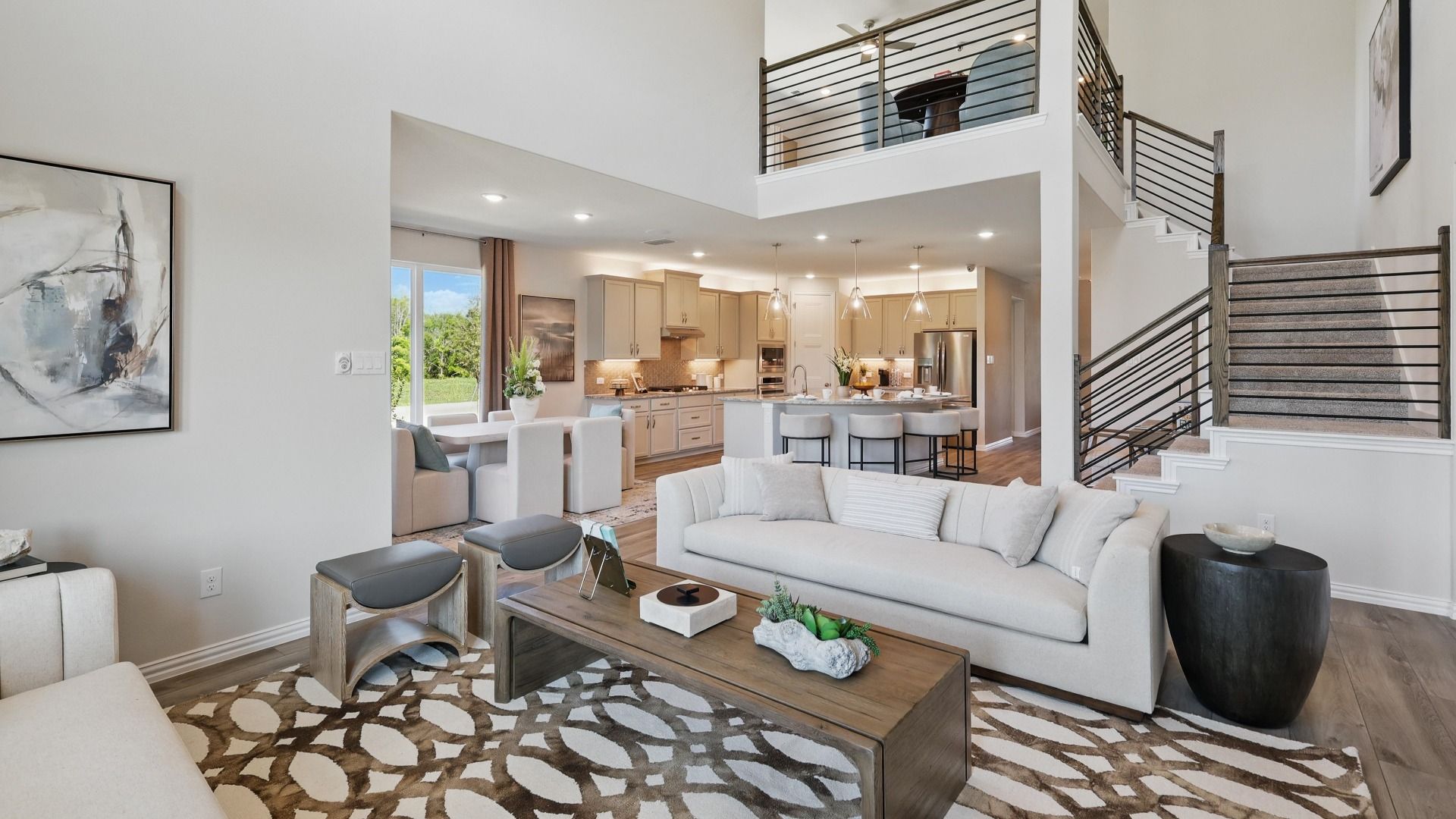 Spacious living area with open sightlines to the kitchen, dining space, and second-floor game room.