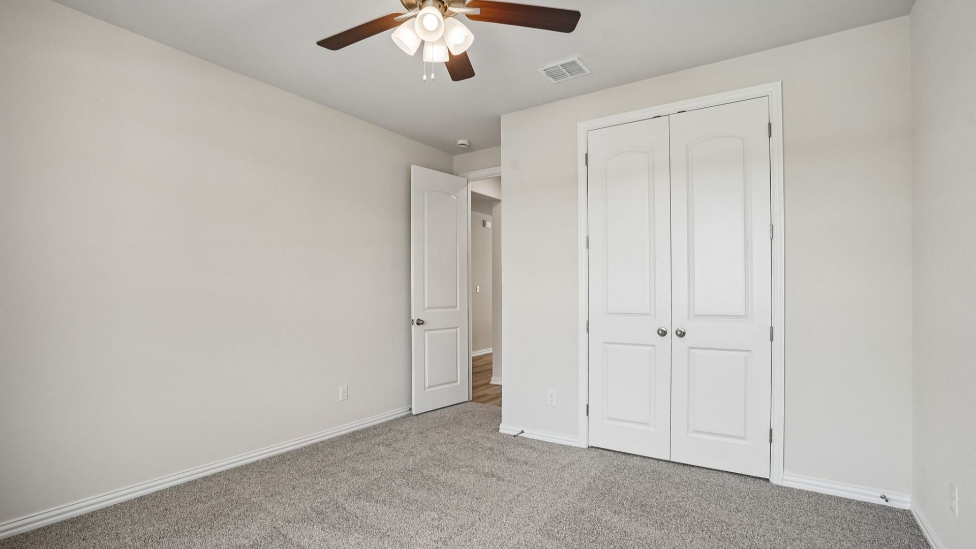 The secondary room provides a versatile space with ample natural light and room for a variety of uses.