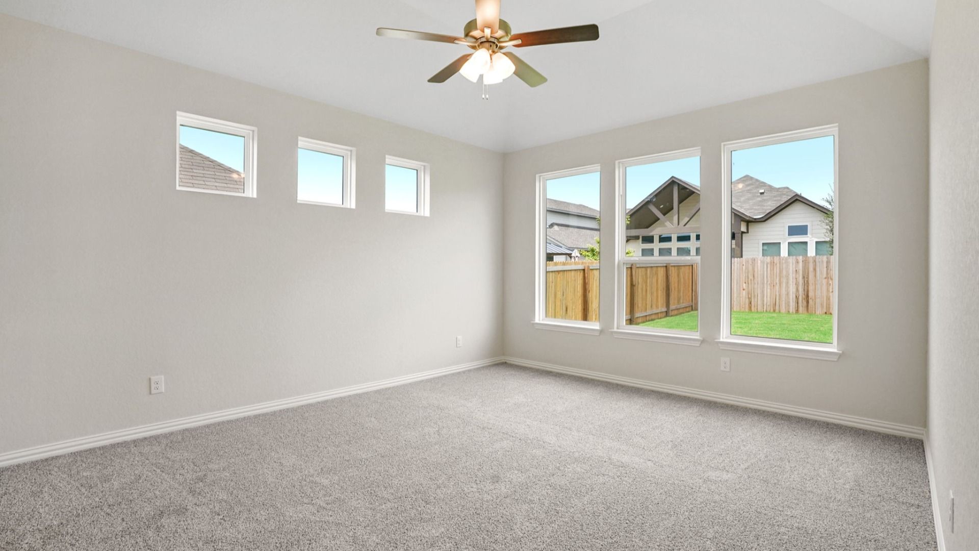 Owner's Suite includes plenty of windows for natural light, along with a ceiling fan for additional comfort