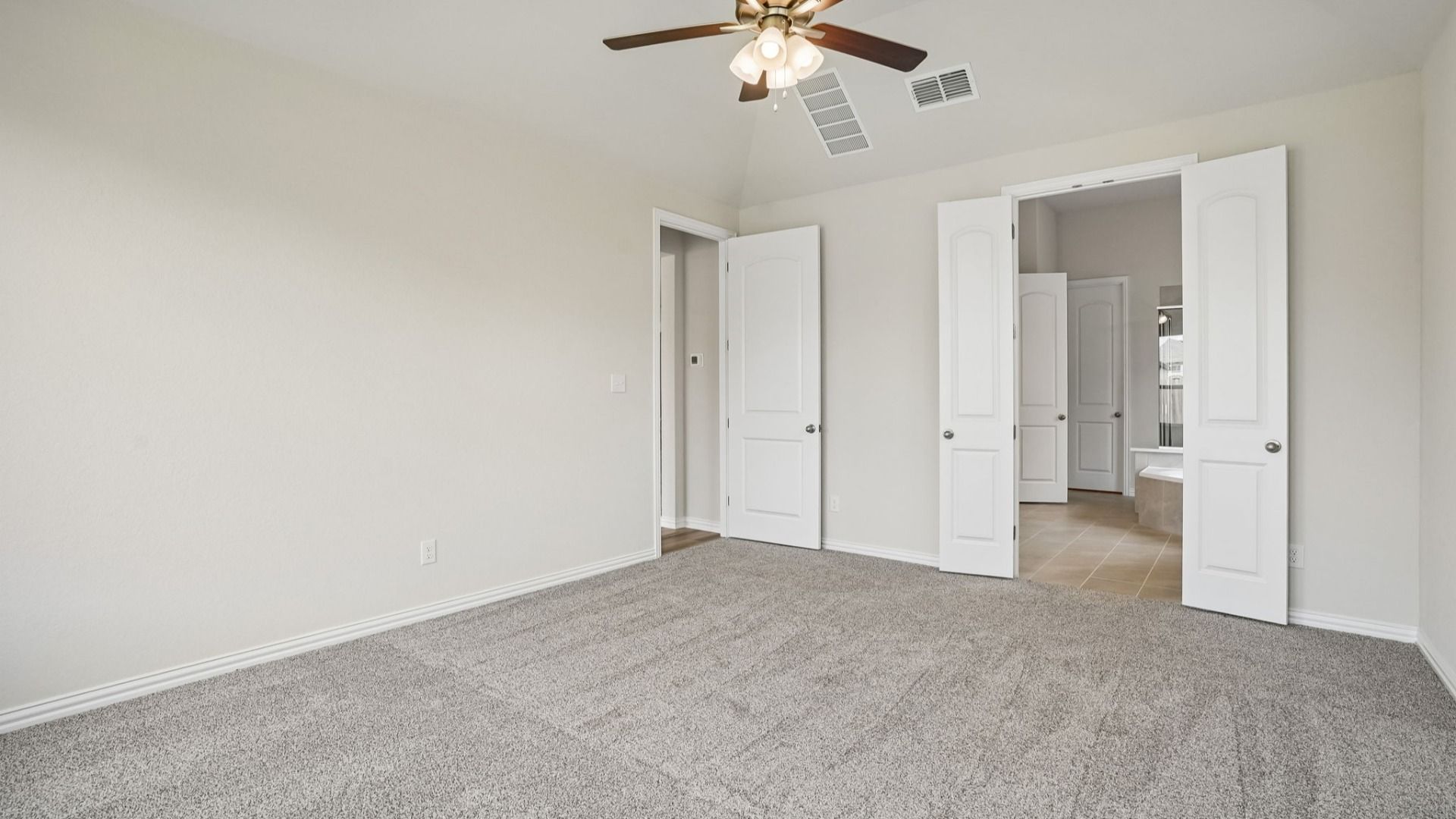 Owner's Suite includes plenty of windows for natural light, along with a ceiling fan for additional comfort