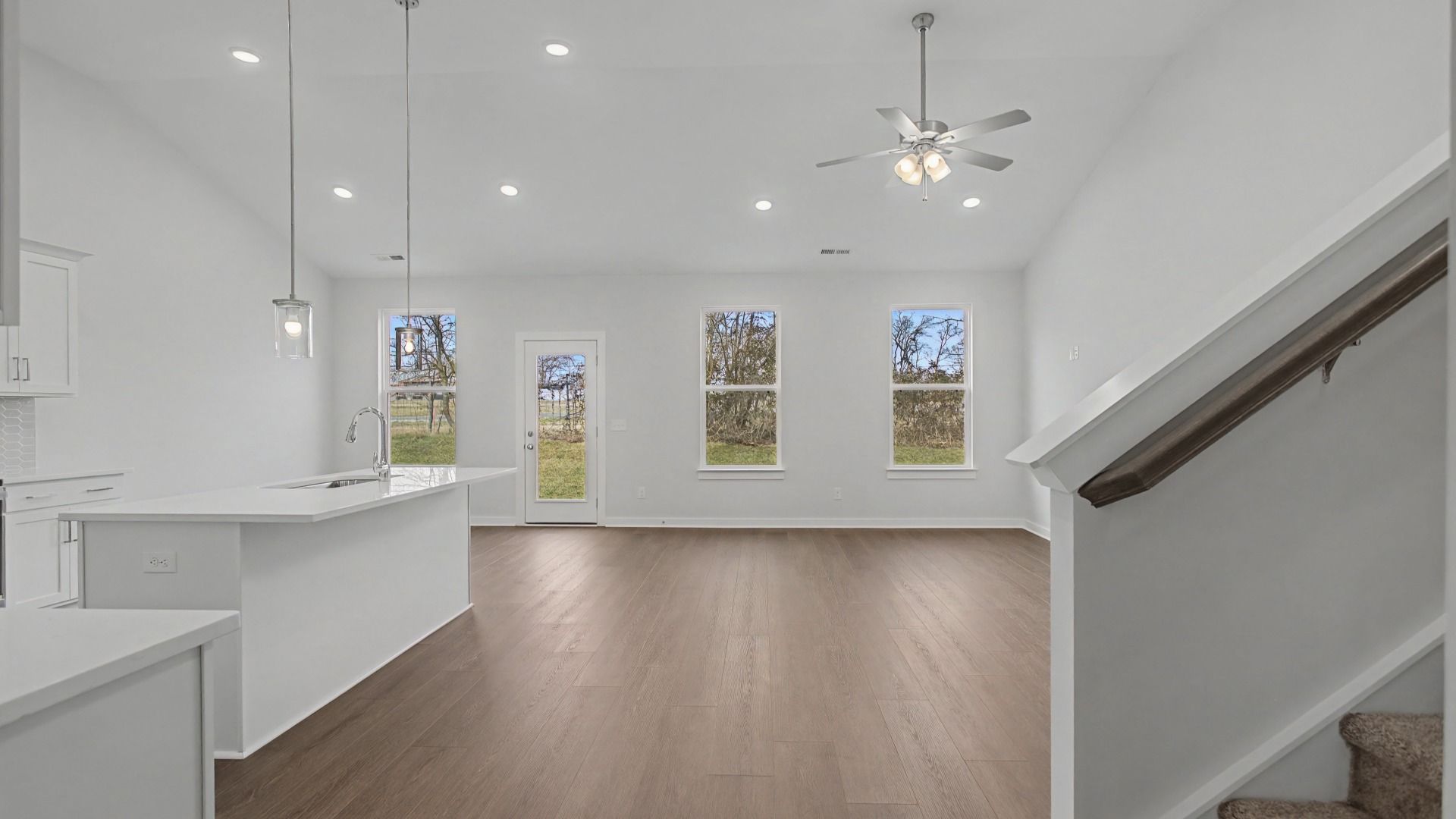 Soaring vaulted ceilings over the kitchen, dining, and gathering areas
