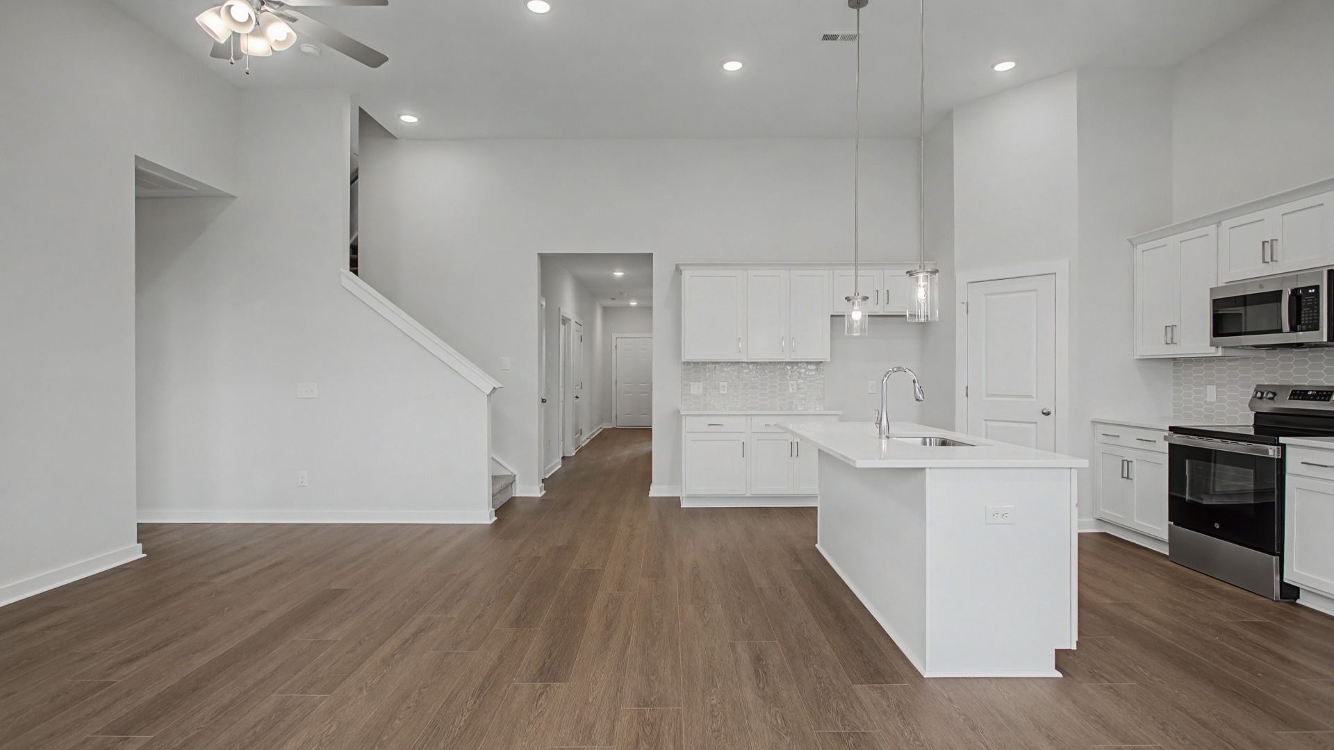 Soaring vaulted ceilings over the kitchen, dining, and gathering areas