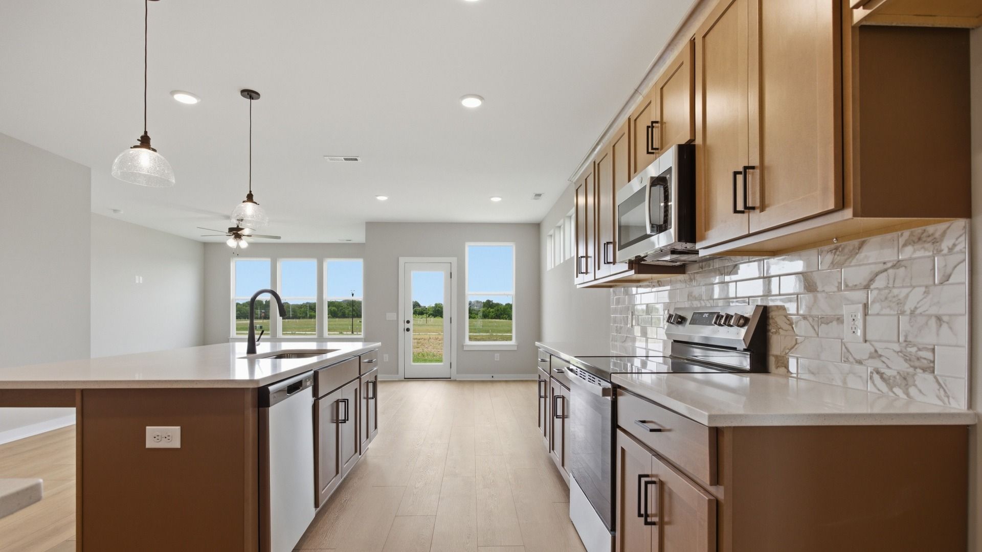 Lassiter plan kitchen with quartz countertops and tile backsplash