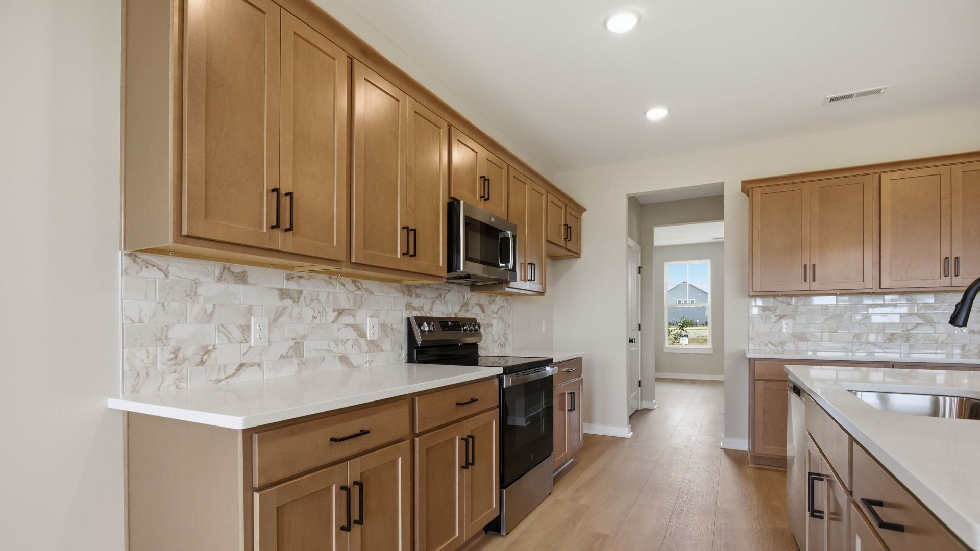 Lassiter plan kitchen with quartz countertops and tile backsplash