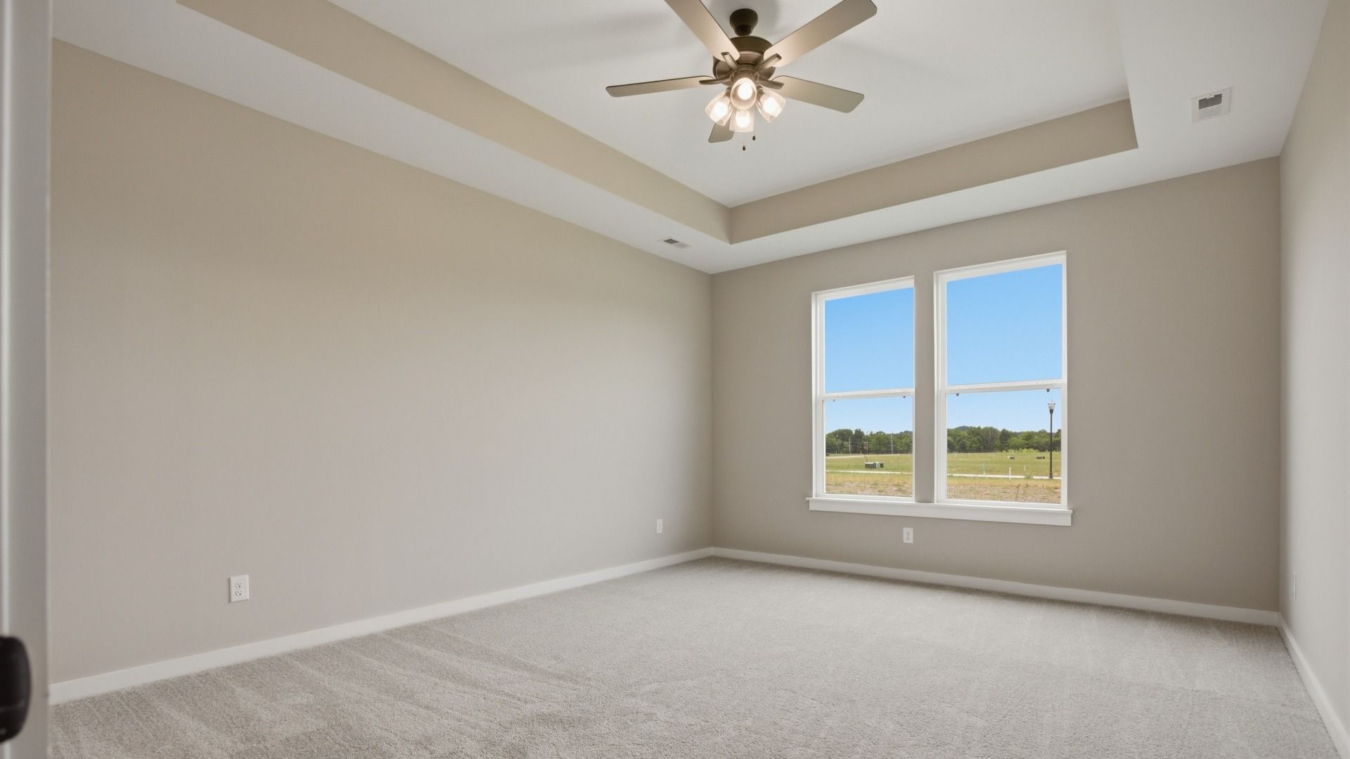 Spacious Primary Bedroom with accent tray ceiling