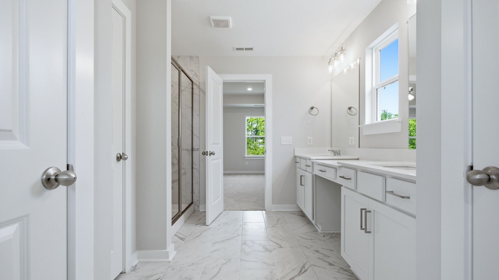 Primary bathroom with tile flooring and shower, and a dual sink vanity area for unwinding or preparing for your day.