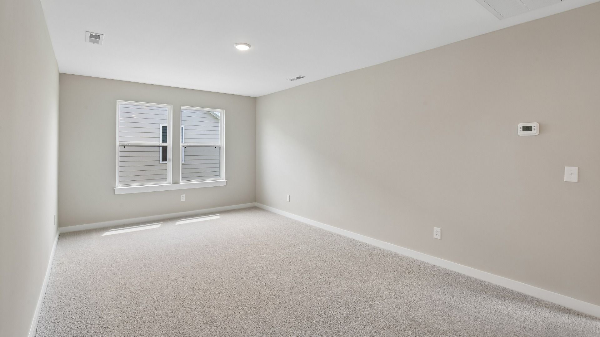 Second Floor Loft area with windows and carpet