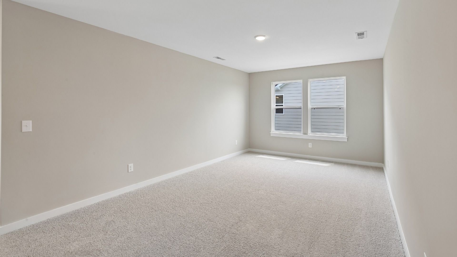 Second Floor Loft area with windows and carpet