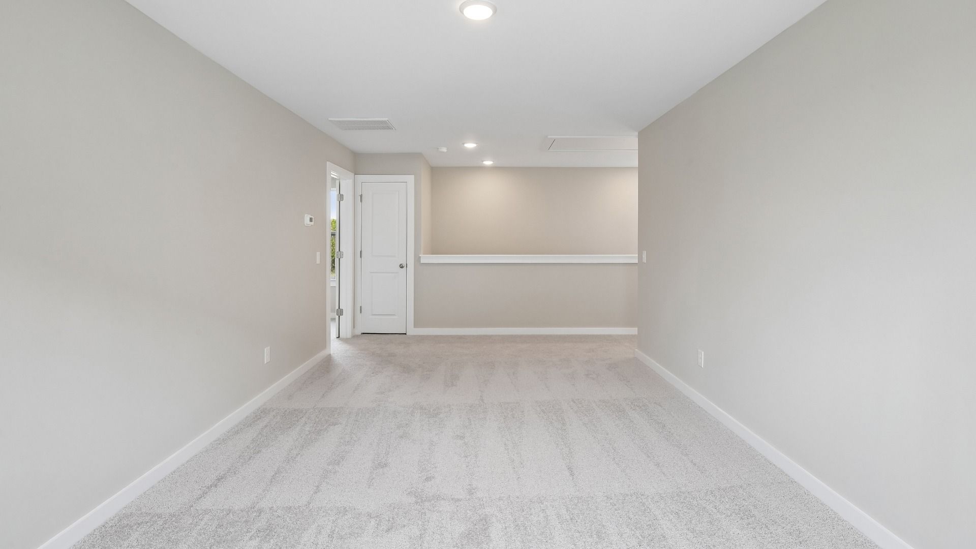 Second Floor Loft area with windows and carpet