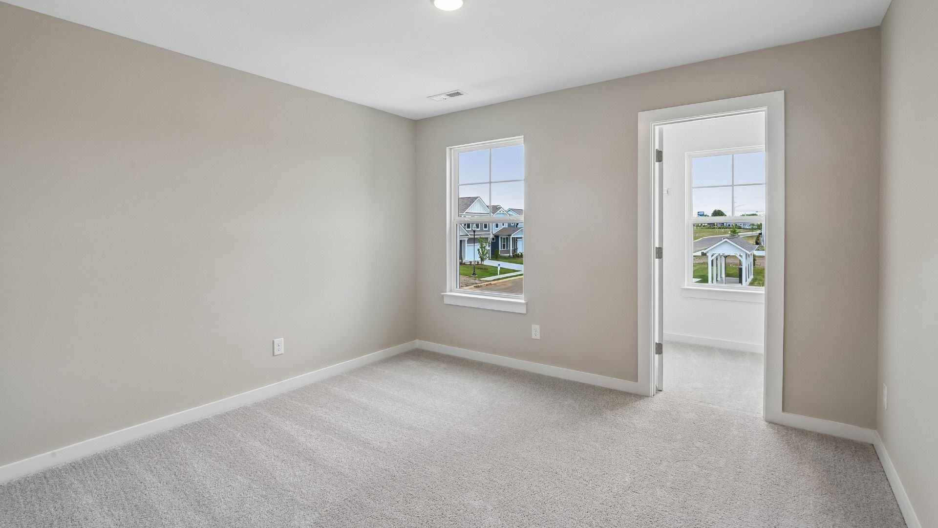 Bedroom with walk-in closet and window