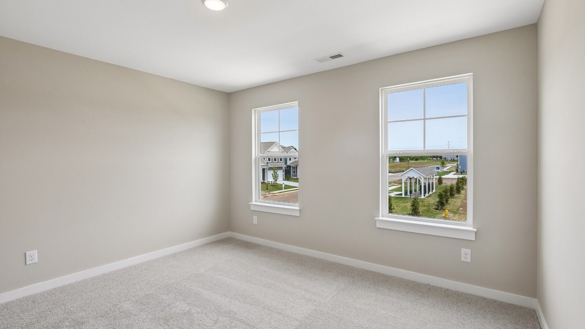 Bedroom with walk-in closet and windows