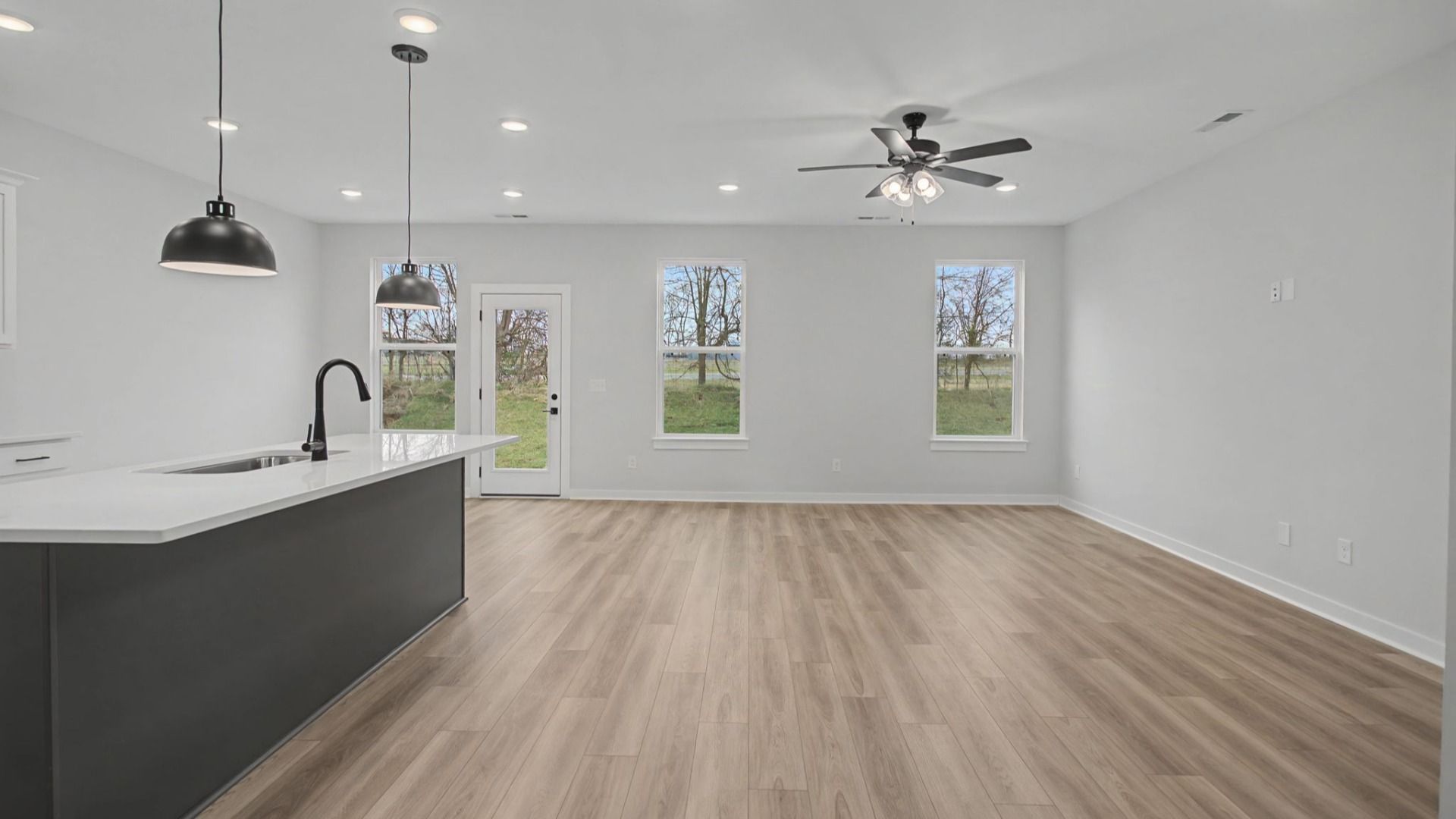 Open-concept first floor with living room near the kitchen and dining area