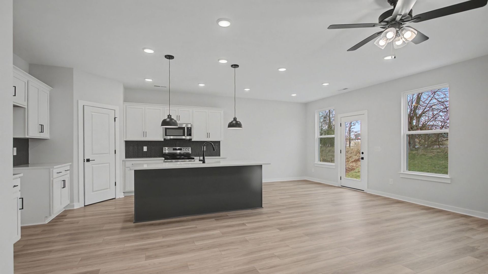 Open-concept first floor with living room near the kitchen and dining area