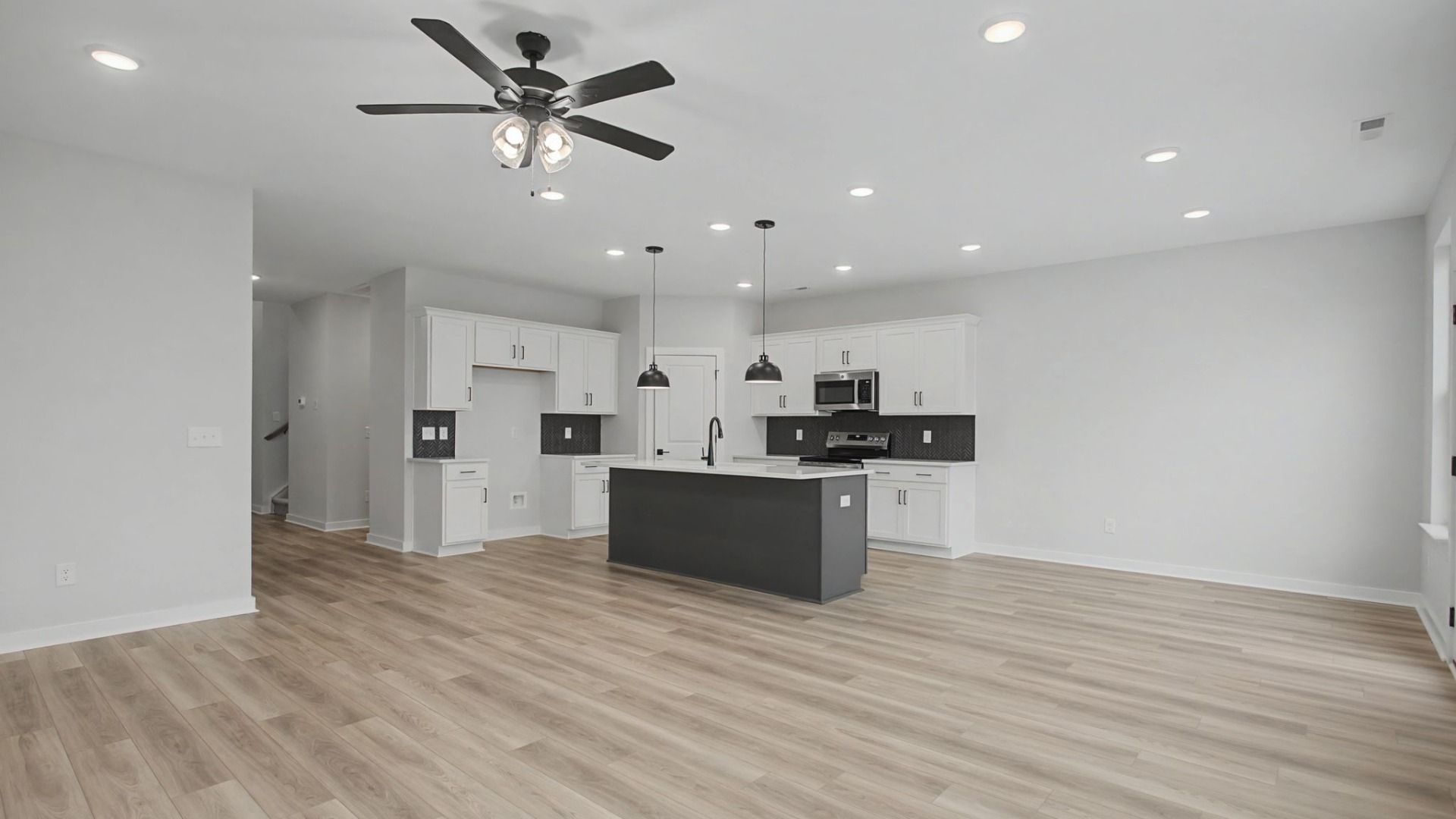 Open-concept first floor with living room near the kitchen and dining area