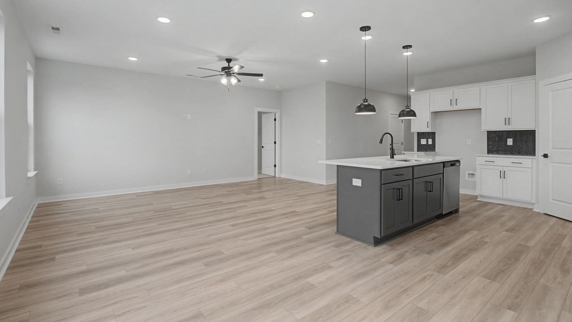Open-concept first floor with living room near the kitchen and dining area