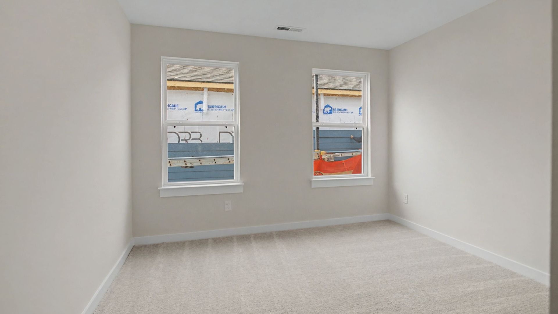 Carpeted Secondary bedroom with two windows