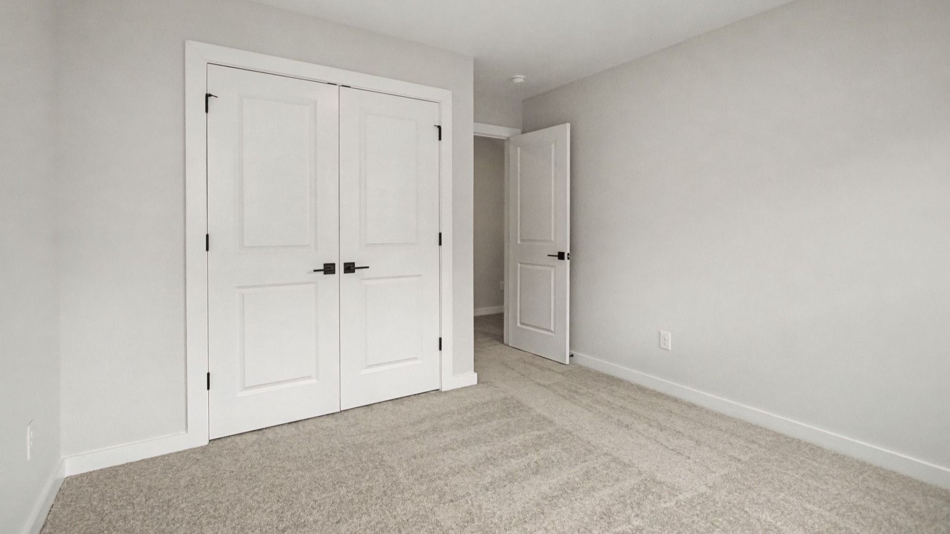Carpeted Secondary bedroom with closet