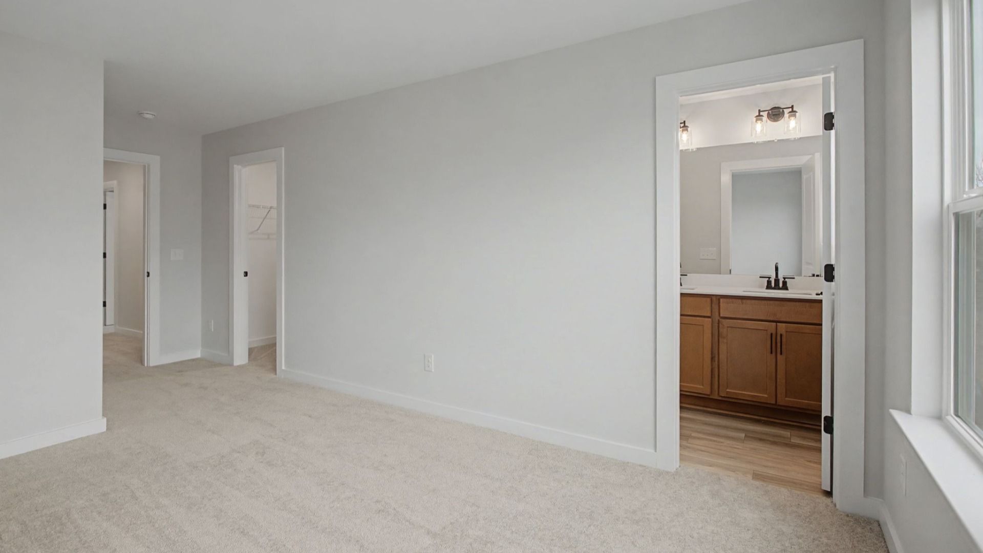 Larger secondary bedroom with walk-in closet and en-suite bathroom