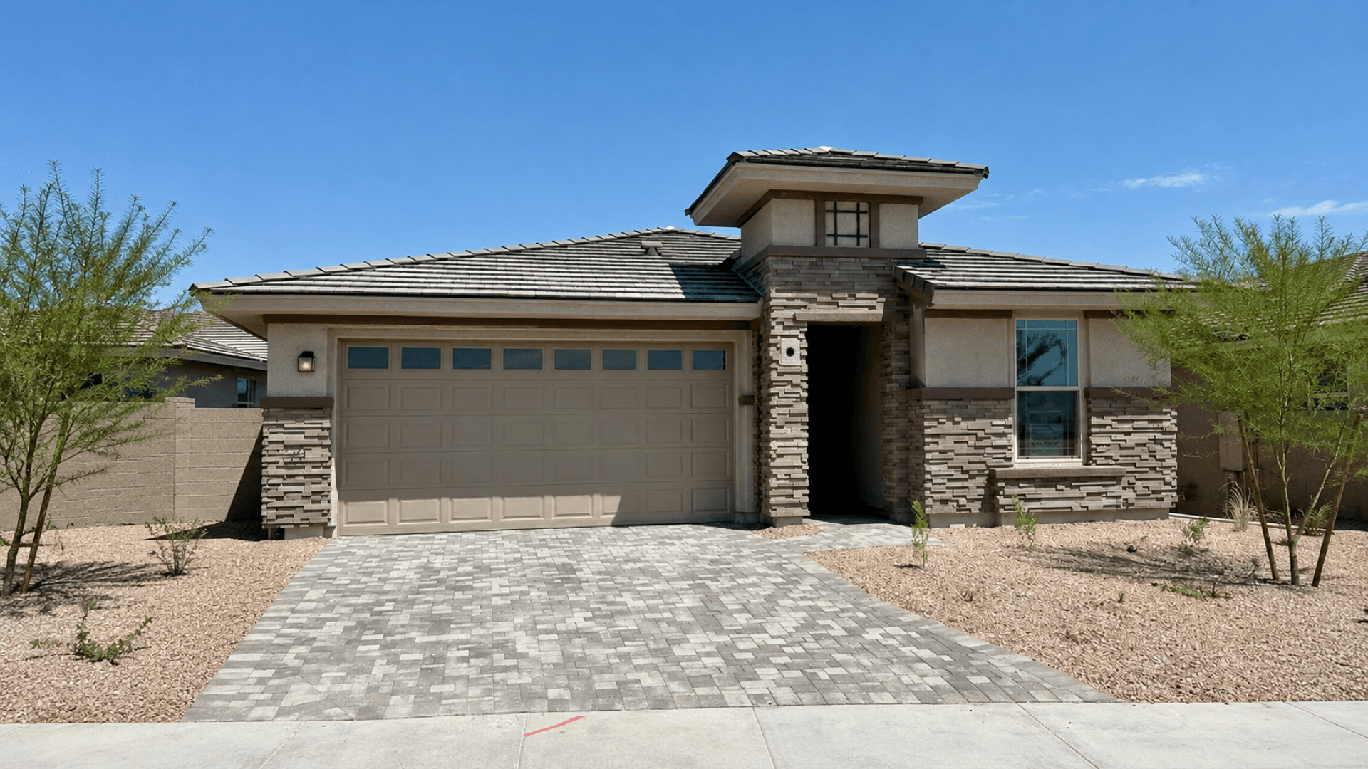 Saguaro Hills at Vistancia Lot 36 by DRB Homes features a welcoming front exterior and desert landscaping in Peoria, AZ.