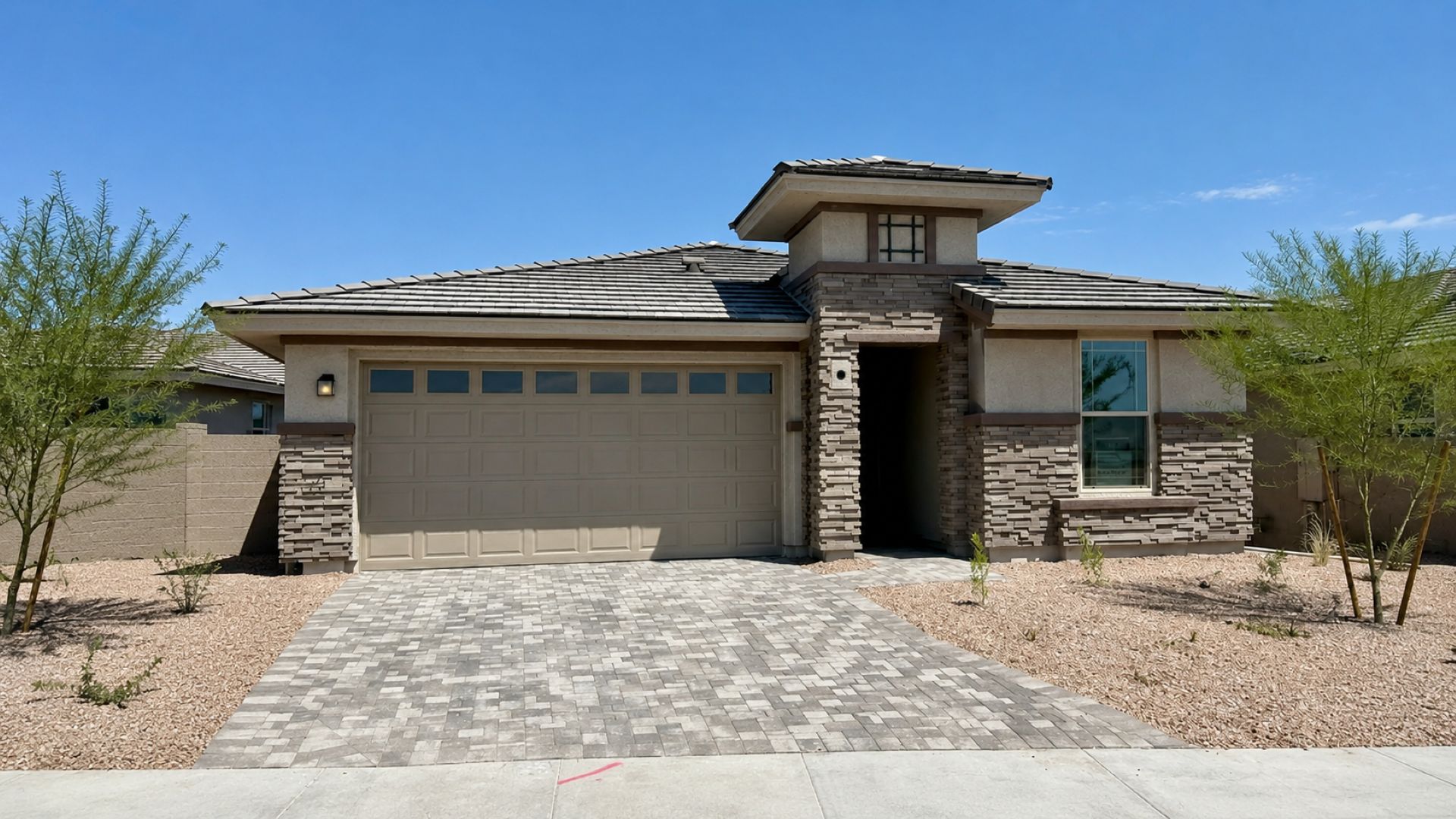 Saguaro Hills at Vistancia Lot 36 by DRB Homes features a welcoming front exterior and desert landscaping in Peoria, AZ.