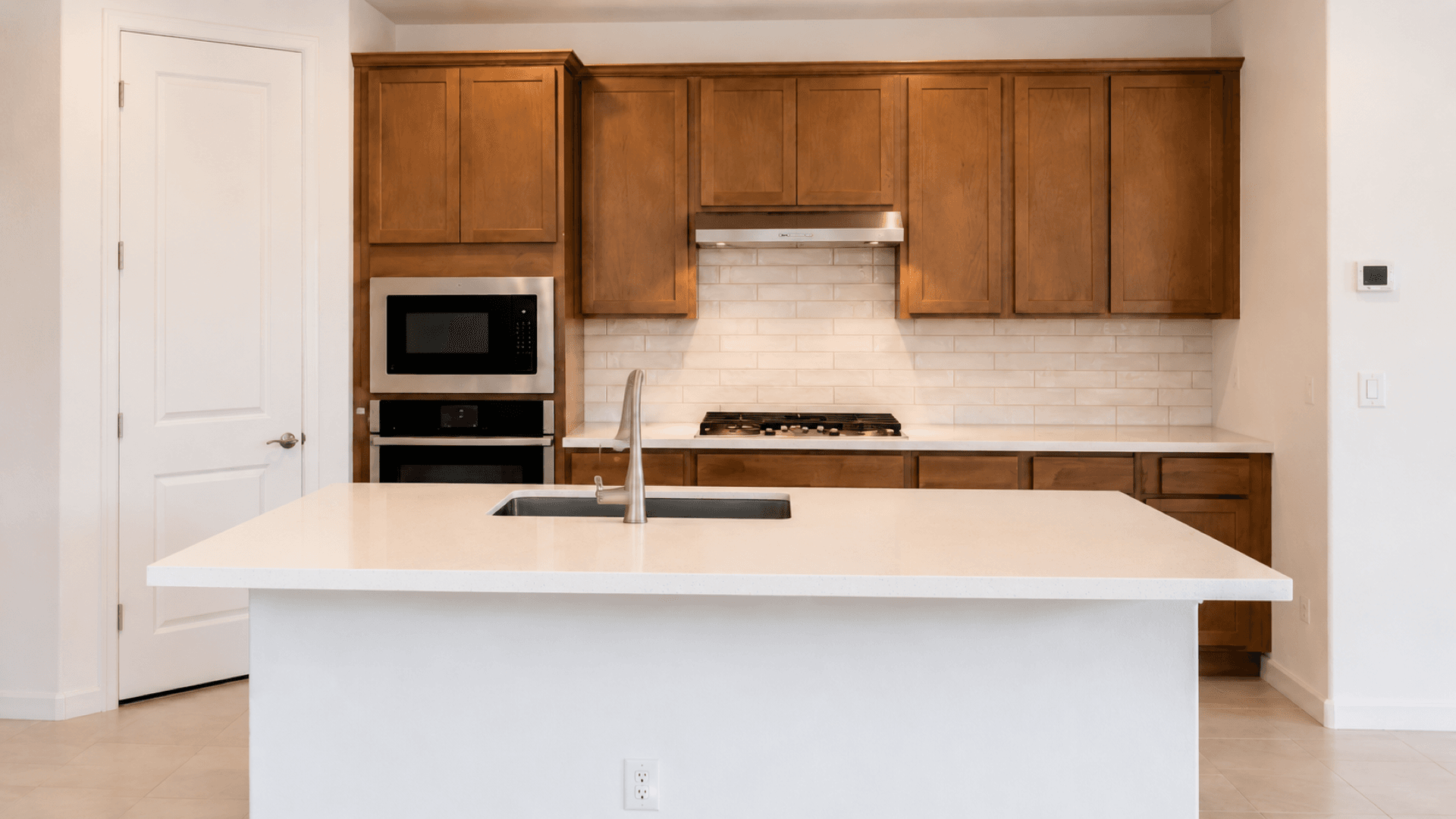 Saguaro Hills at Vistancia Lot 36 interior kitchen with quartz island and wood cabinets, Peoria, AZ | DRB Homes