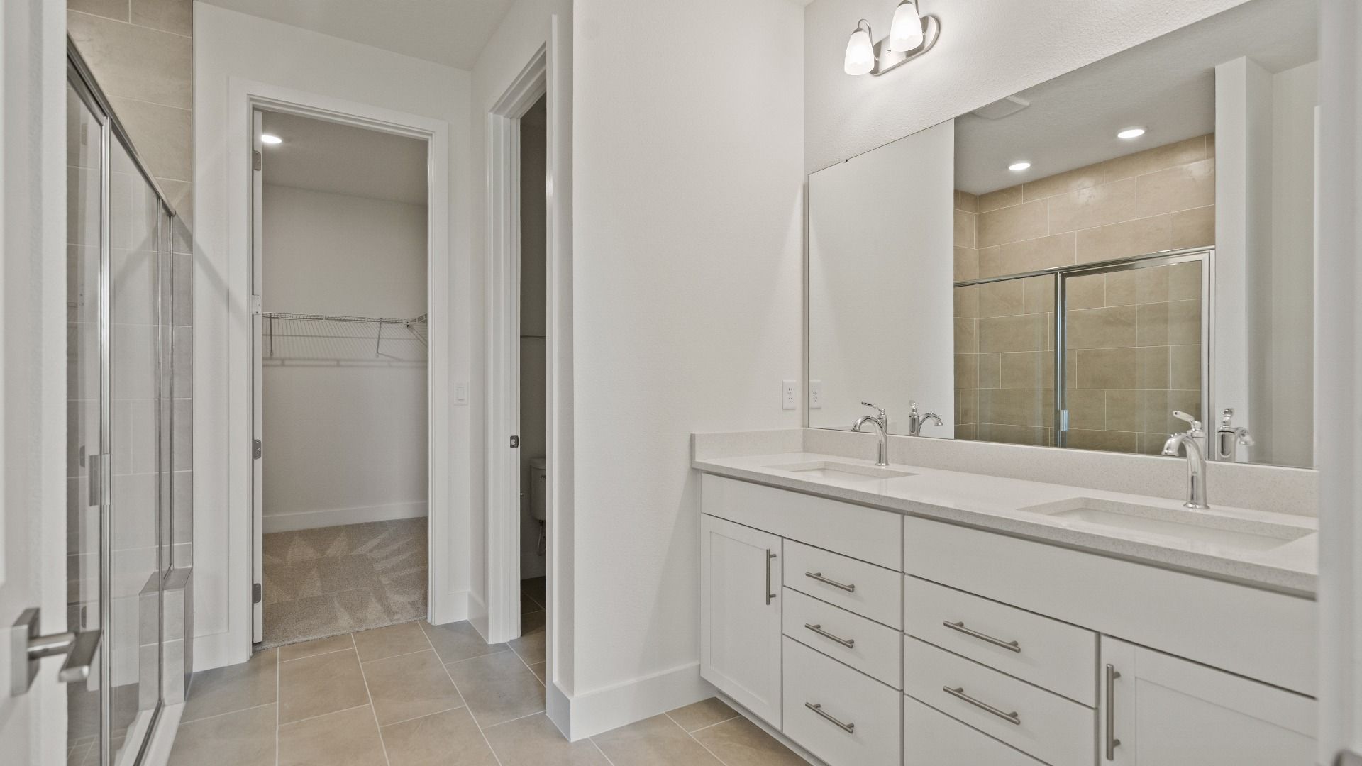 Primary En Suite Bath and Spacious Walk-in Closet in the Buttonwood Floor Plan by DRB Homes Ardisia Park in New Smyrna Beach