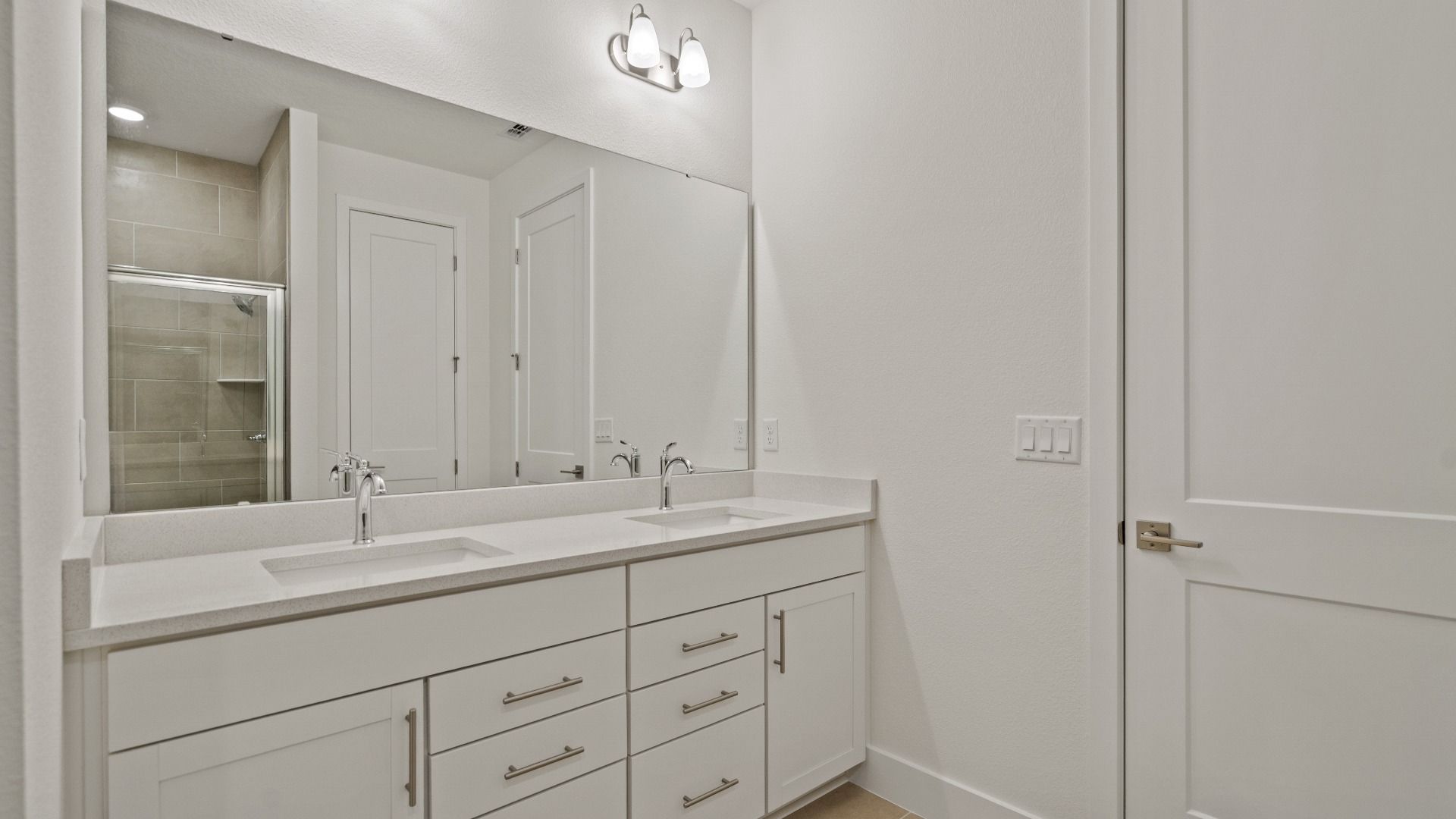 Primary En Suite Bath with dual sinks in the Buttonwood Floor Plan by DRB Homes Ardisia Park in New Smyrna Beach