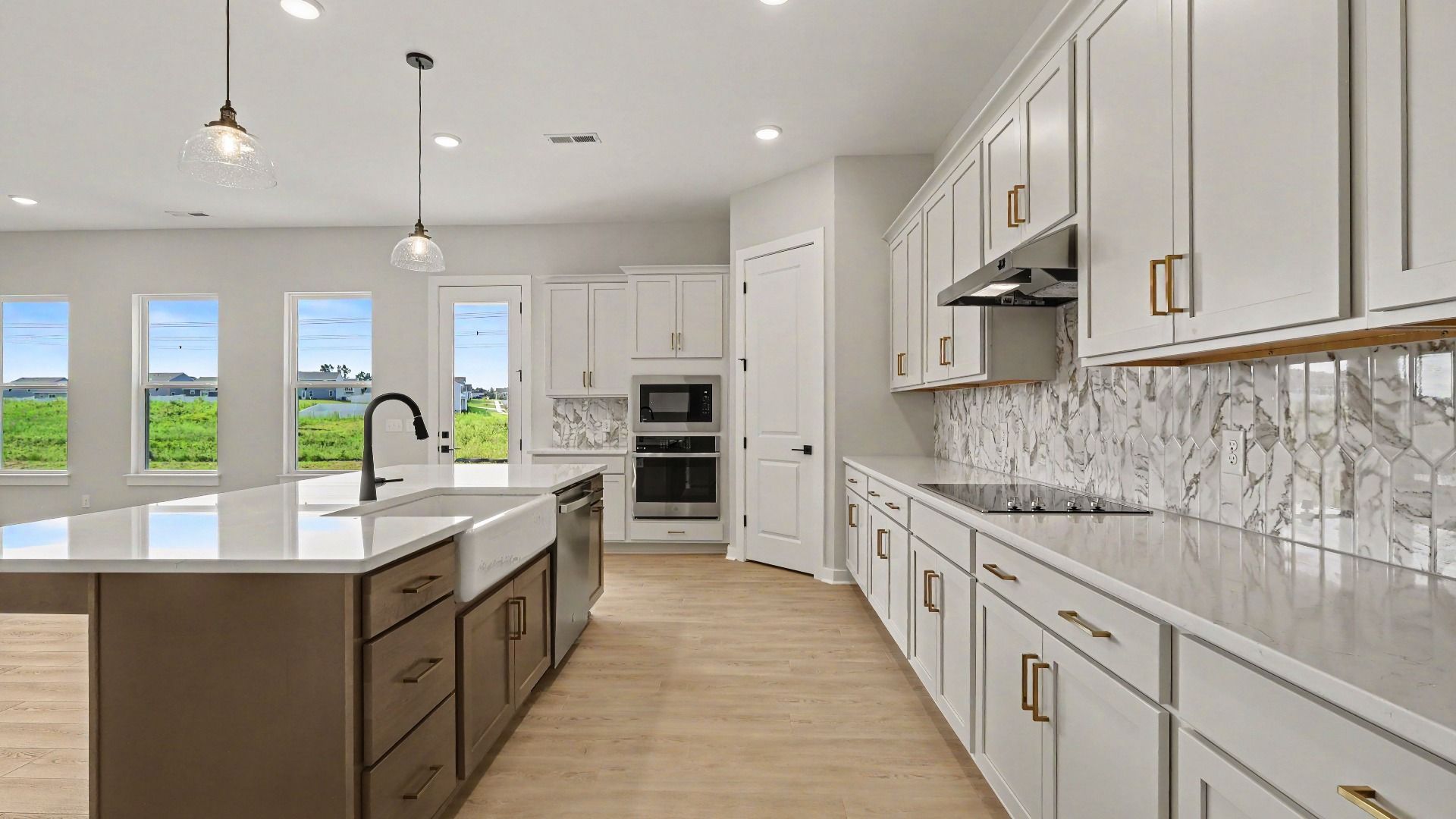 Huge kitchen with quartz countertops and accent backsplash, with a corner pantry and tons of workspace