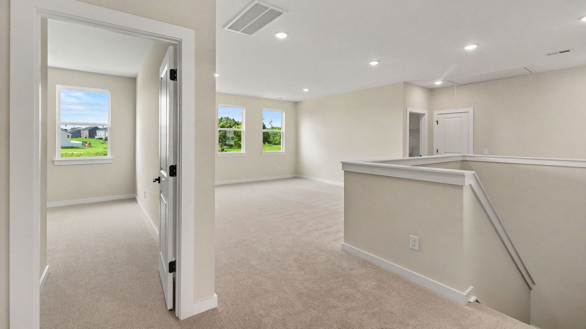 View from the second floor landing showing the loft area and a secondary bedroom