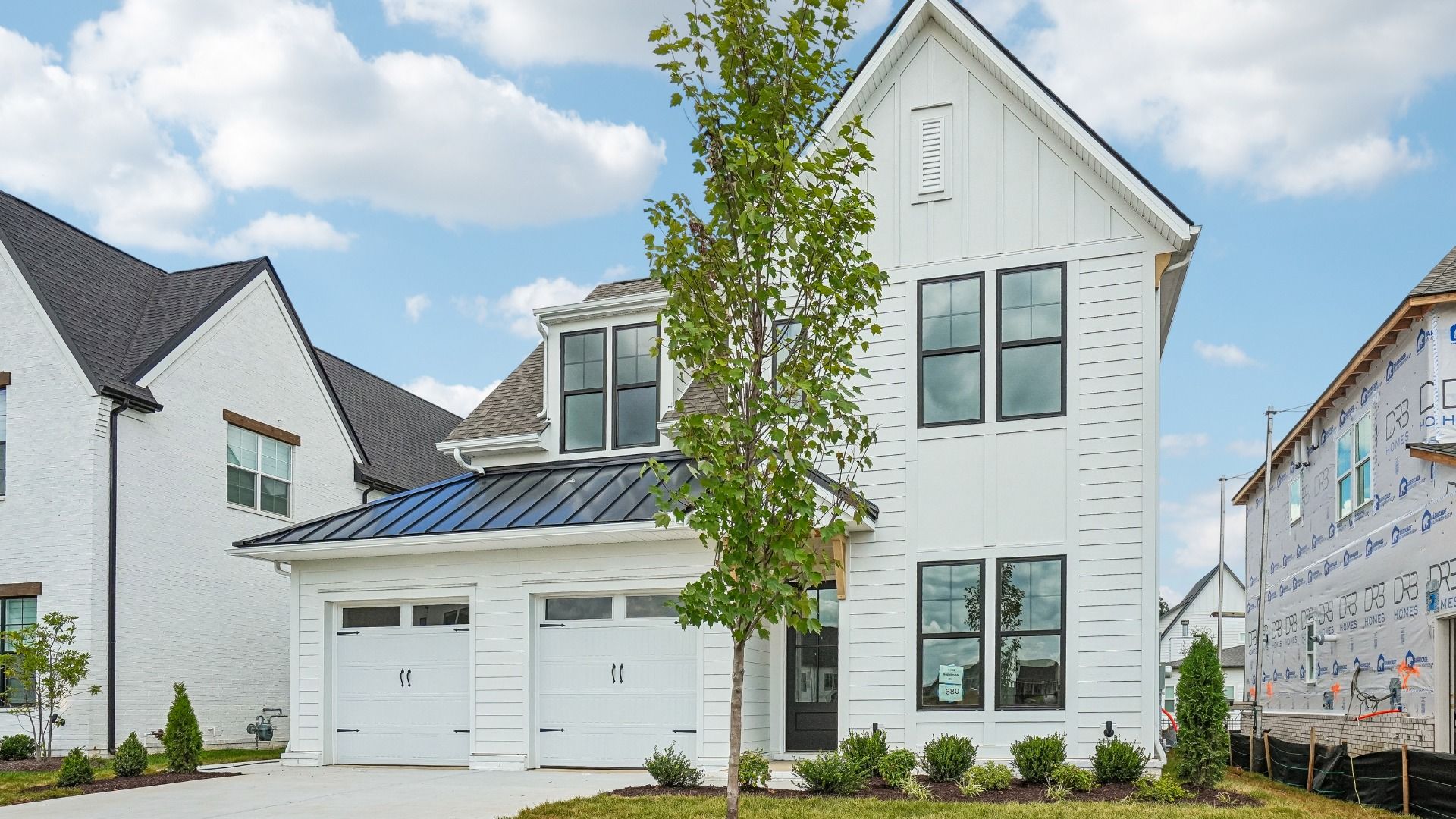 Exterior of home with Shelton Square's signature high-end white brick and siding with black accents