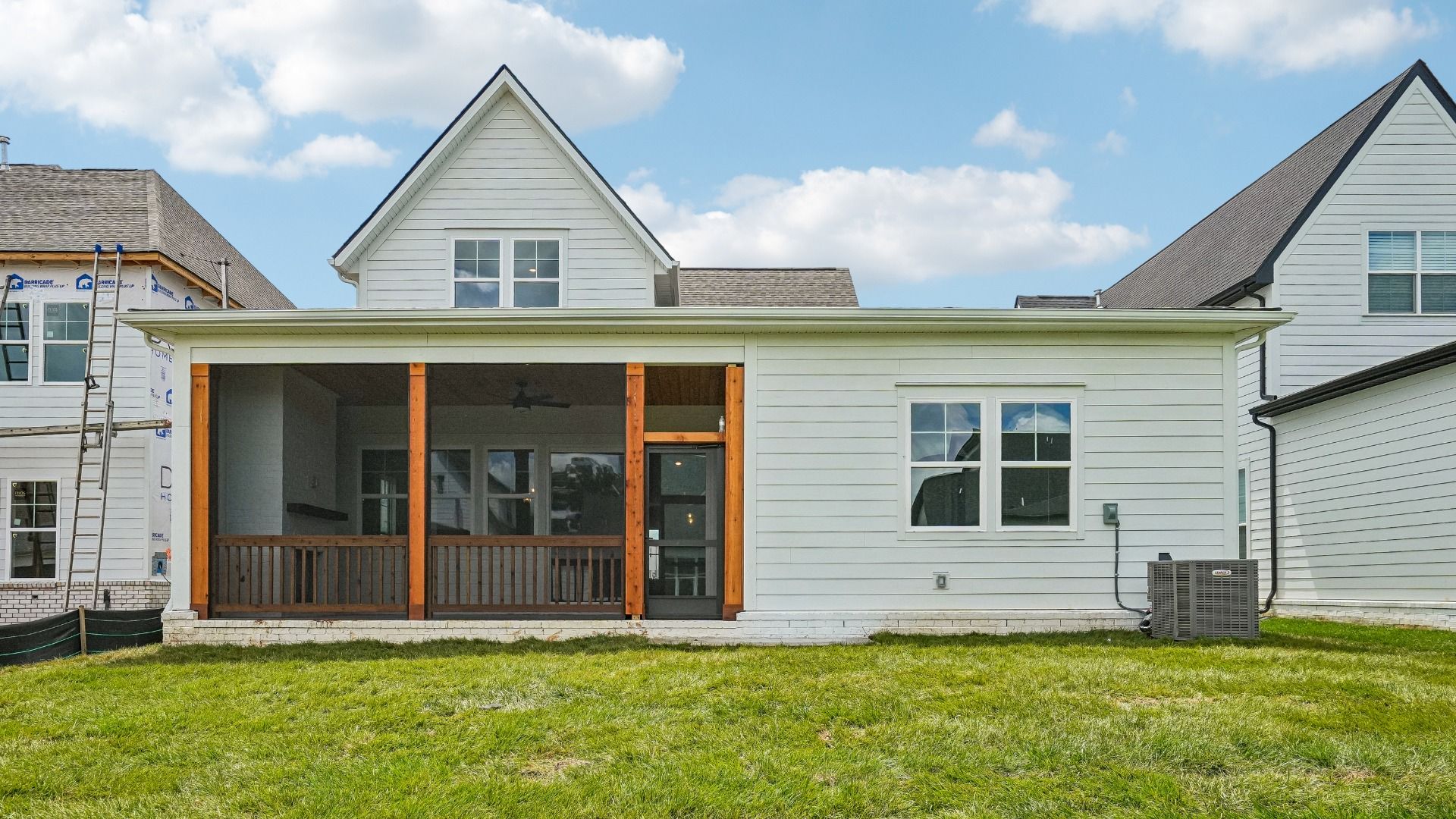 Sodded backyard with view of screened in porch
