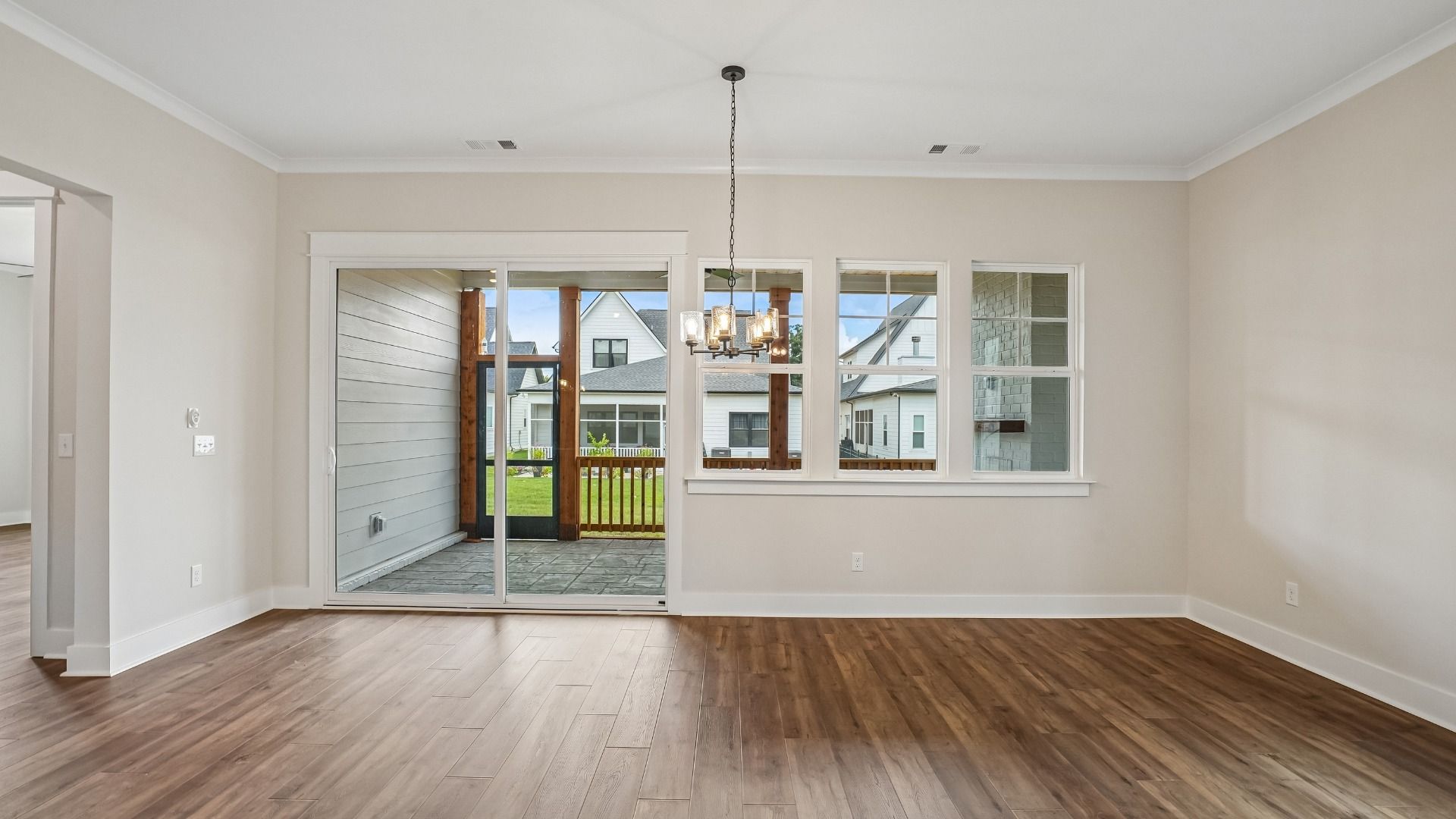 Dining area with light fixture and nearby screened-in outdoor living
