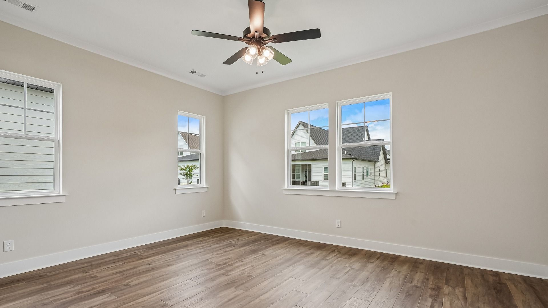Primary Bedroom with ceiling fan and hard surface flooring
