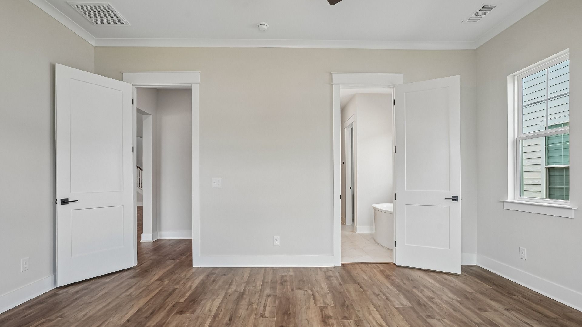 Primary Bedroom with en-suite bathroom and hard surface flooring