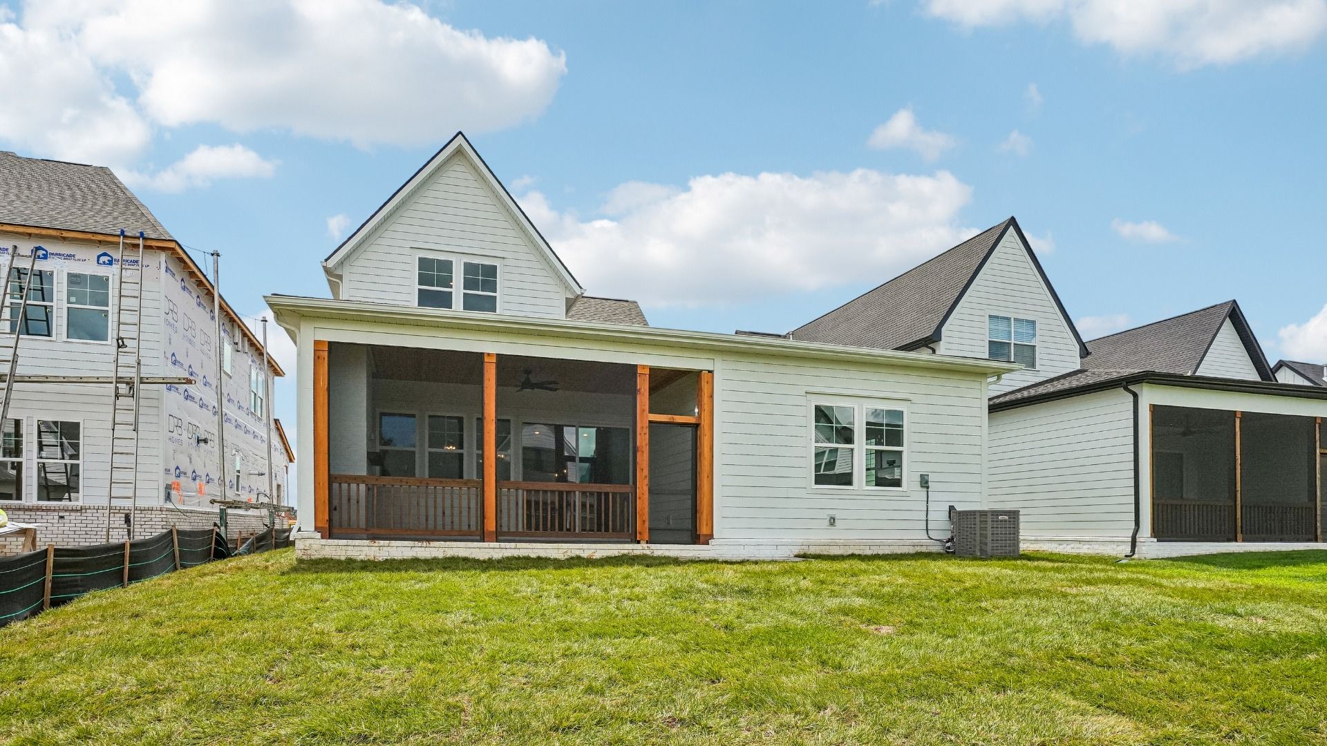 Sodded backyard with view of screened in porch