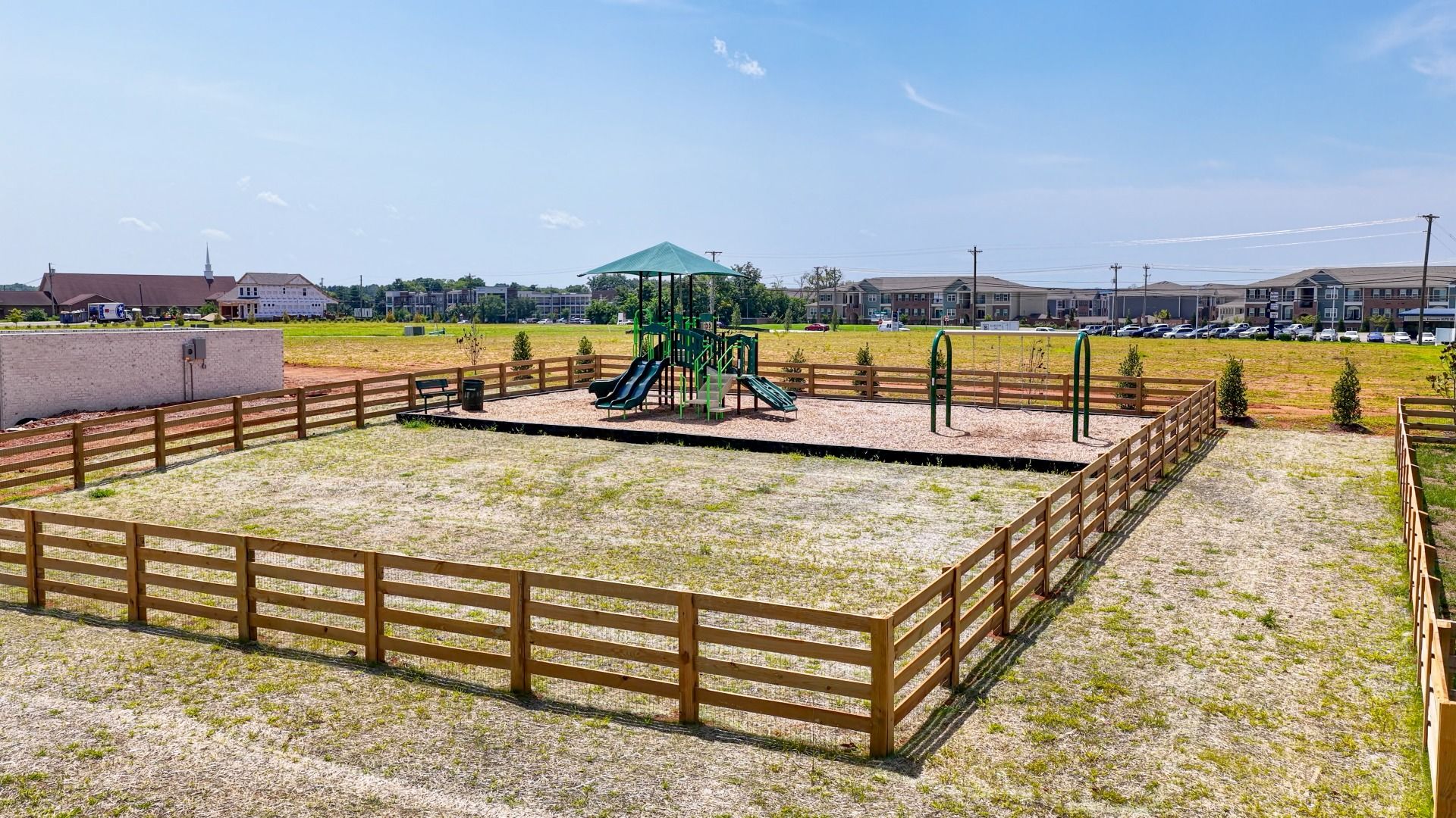 On-site Community Playground and Swing Set with grass area