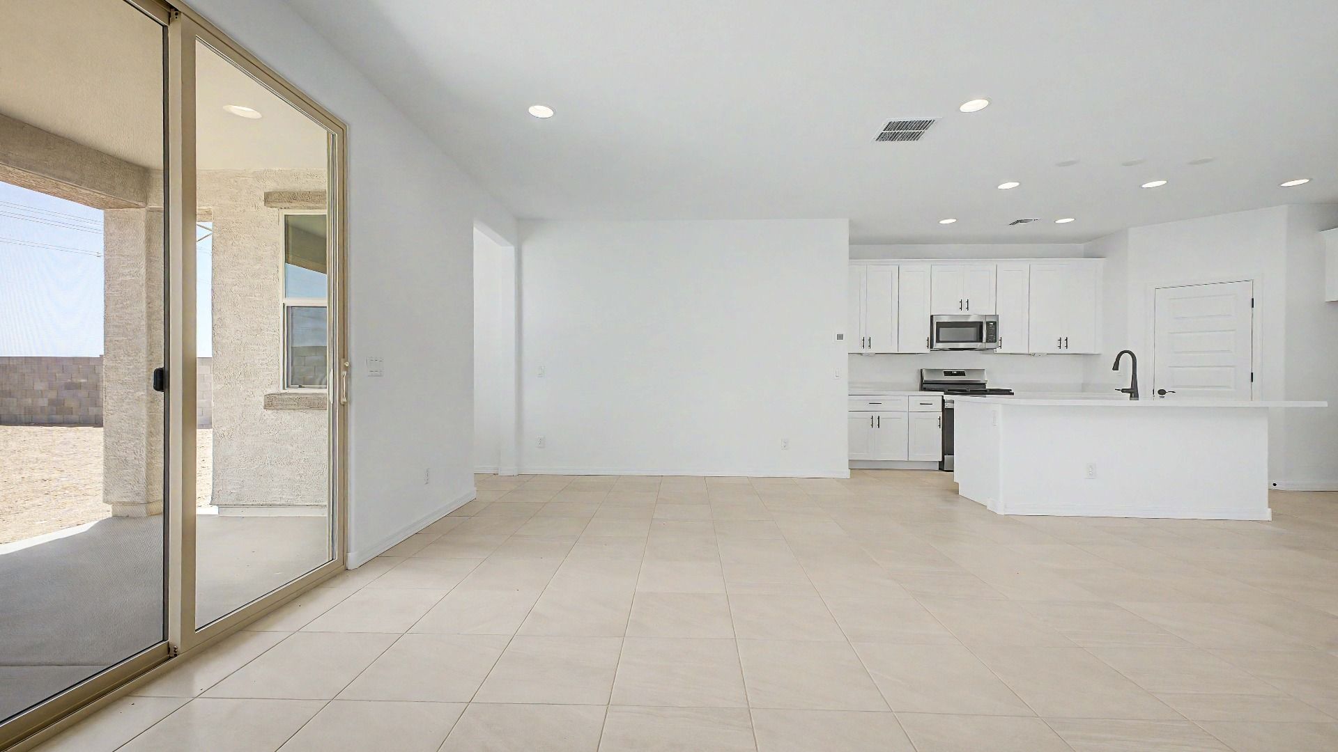 Bright great room with 12-ft sliding glass door to patio in this quick move-in home at Saguaro Hills at Vistancia.