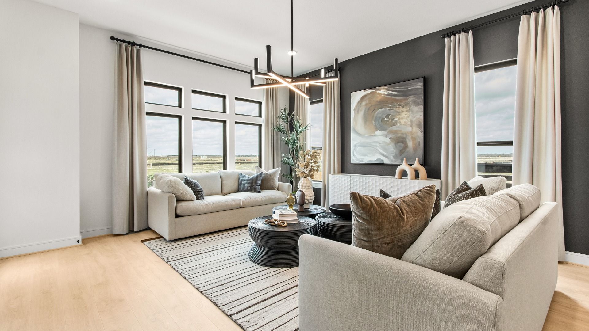 Natural light and modern fixtures create a bright, stylish living room in this Bridgeland Central home.