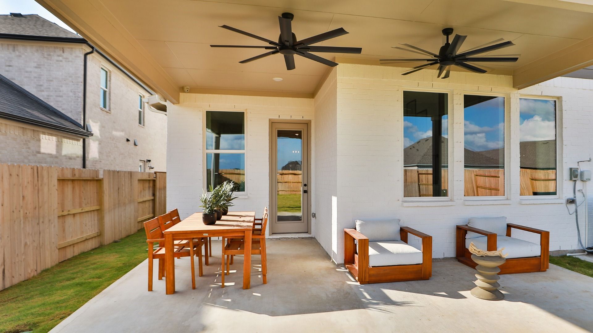 Extended Rear Patio with ceiling fans for comfortable outdoor living.